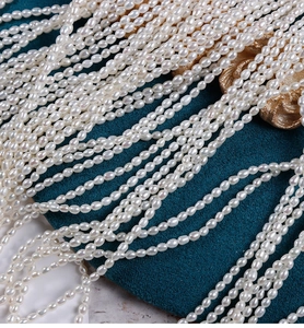 Close-up of 2.5mm lustrous white freshwater seed pearls on deep blue velvet background