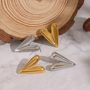 Minimalist gold and silver 3D heart stud earrings featuring smooth mirror finish surfaces