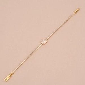 Macro detail of gold-plated tennis bracelet with square-cut zircon and claw setting