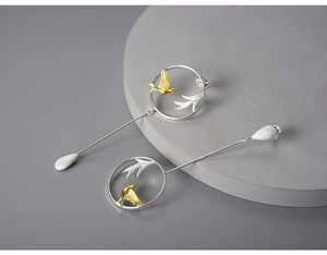 Detail of S925 sterling silver bird and leaf earring with elegant matte gold finish