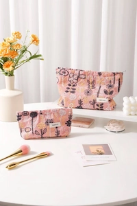 Detailed view of two pink floral embroidery canvas makeup bags with zip closure