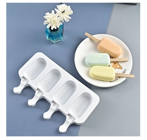 Detail of 4-cavity silicone popsicle mold with finished colorful fruit ice pops on a plate
