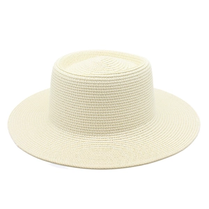 Close-up of fine weave texture on a cream-colored wide brim flat top straw hat