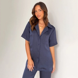 Close-up of navy blue satin loungewear set featuring lapel collar and silk texture