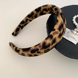 Macro detail of wide leopard print headband with textured fabric and non-slip lining