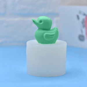 3D duck shaped silicone mold for DIY soap, candles, and fondant on light blue background