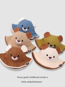 Detail view of colorful cotton kids bucket hats with cute bear ears and embroidery