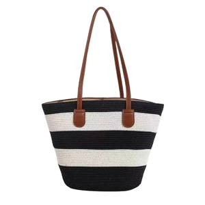 Chic black and white striped woven straw tote bag with premium brown leather handles