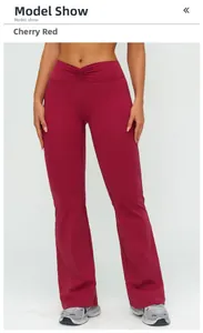 Detail of high waisted flare yoga pants in cherry red with V-shaped waistband design
