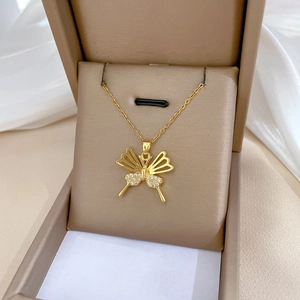 Detailed close-up of a hollow butterfly necklace with white zircon in a jewelry box