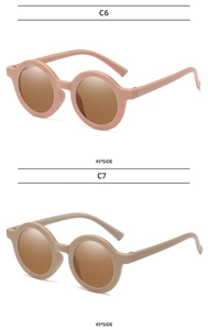 Classic round children's sunglasses in matte pink and khaki frames with 45-degree view