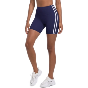 Detail showing high-waisted navy yoga shorts with white side stripes and stretch fabric