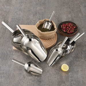 Set of seven stainless steel scoops for ice and grain on a rustic grey textured background