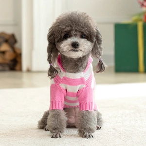 Detailed close-up of pink and white striped knit dog sweater with ribbed collar texture
