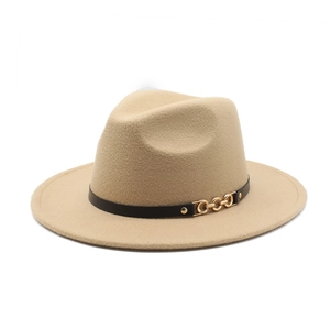 Detail of camel wool fedora hat featuring a black leather band and gold chain accent