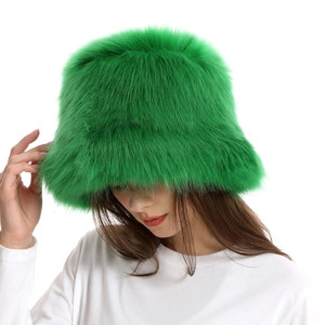 Close-up of fluffy bright green faux fur bucket hat with thick plush texture and warm lining