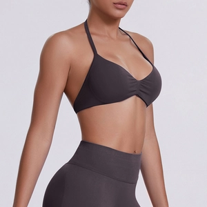 Close-up of seamless dark brown high-stretch halter yoga bra with matte fabric texture