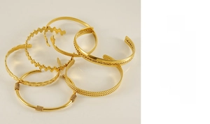Detailed set of adjustable golden stainless steel C-shaped bracelets with varied textures