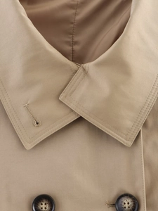 Detail of classic khaki trench coat collar and dark marble buttons with twill fabric texture