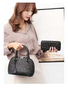 Detailed view of black sequined shell handbag and matching wallet held by a model