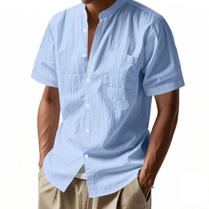 Detail of light blue linen shirt featuring a standing collar and buttoned chest pocket