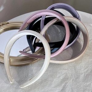 Silky sponge headbands in multiple colors displayed with elegant vintage mirror frame