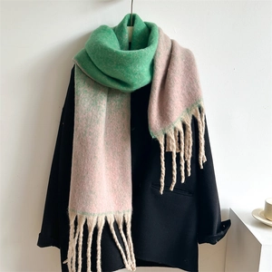 Detailed view of pink and green gradient scarf with tassels on a black suit jacket