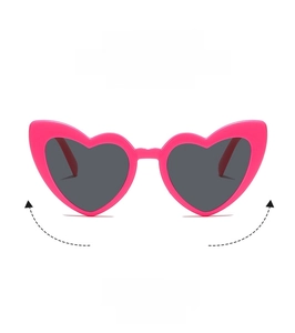 Detailed view of pink heart-shaped sunglasses with dark grey lenses and high-quality frame