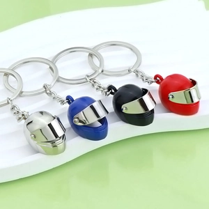 3D mini motorcycle helmet keychains in silver, blue, black, and red metallic finishes