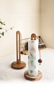 Detailed view of standing walnut wood paper towel holder with decorative wooden bead tie