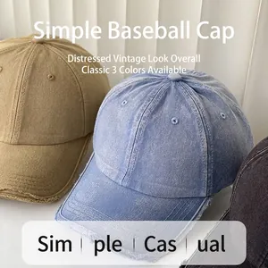 Washed cotton baseball caps in khaki, denim blue, and dark grey with vintage distressed style