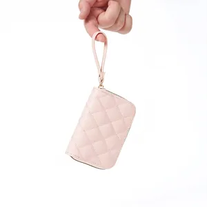 Pink quilted rhombic card holder with zipper and wristlet, stylish compact design