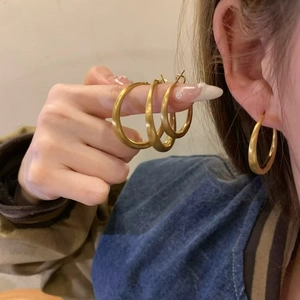 Fashionable matte gold hoop earrings for women showing high-end minimalist jewelry style