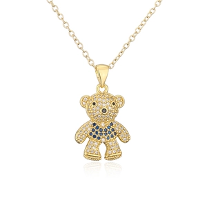 Gold teddy bear pendant necklace with sparkling crystal and blue stone detail