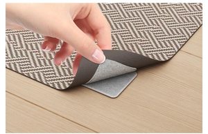 Close-up of the anti-slip sofa pad adhesive fastener on light wood floor texture