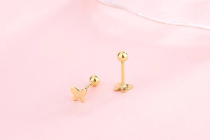Detailed close-up of butterfly stud earrings with secure gold screw ball backing