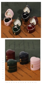 Detail of vintage heart shaped velvet ring boxes in pink navy green and burgundy colors