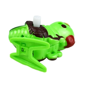Detail view of clockwork green caterpillar toy with white winding knob and mechanical base