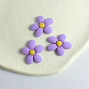 Three lavender resin flower charms with yellow centers for DIY hair accessory making