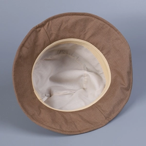 Detail of the inner beige lining and sweatband of the brown linen sun hat for women