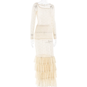 Close-up of beige lace dress featuring layered ruffles and detailed sheer texture