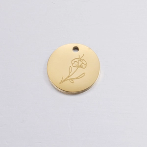 Detailed close-up of golden round pendant featuring engraved birthday flower design