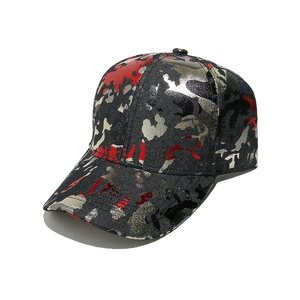 Detail of red camouflage baseball cap showing glossy metallic texture and arched brim