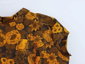Detail of vintage jacquard fabric with gold floral embroidery on the stand collar and shoulder