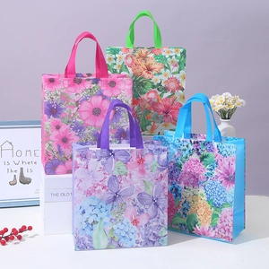Floral non-woven gift bags with reinforced handles in pink, blue, purple, and green colors