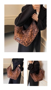 Detailed close-up of large leopard print tote bag with brown trim and brand label