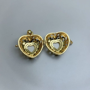 Gold hollow heart locket pendant with intricate filigree design for photo storage