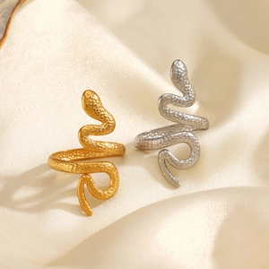 18K gold-plated snake-shaped wrap ring in gold and silver colors on silk fabric