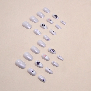 Halloween ghost press-on nails in light purple with star patterns and witch hat ghost art