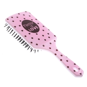 Detail of pink polka dot hairbrush featuring Family is LOVE text on large air cushion base